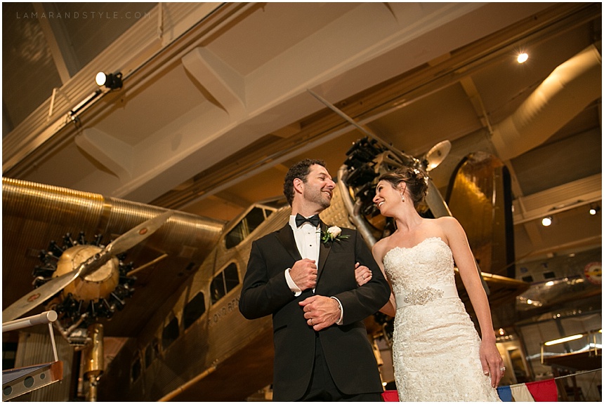 Bride and groom in front of airplane at the Henry Ford Museum
